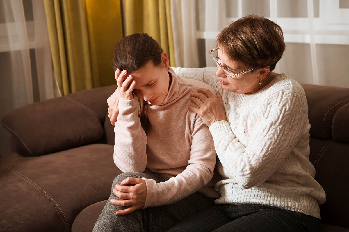 mom with arms around distraught daughter asking does my loved one need a detox center