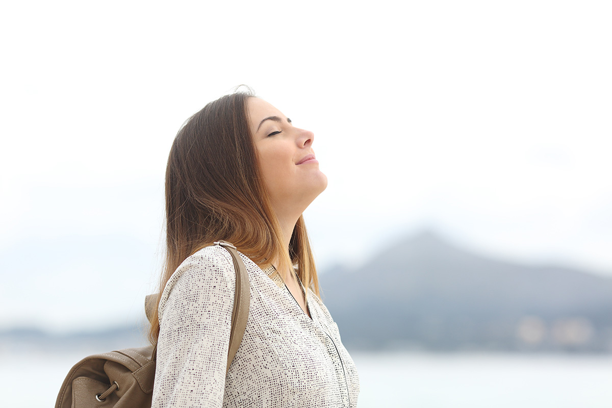 young woman taking in the fresh air thinking about How Does Drug Detox Work