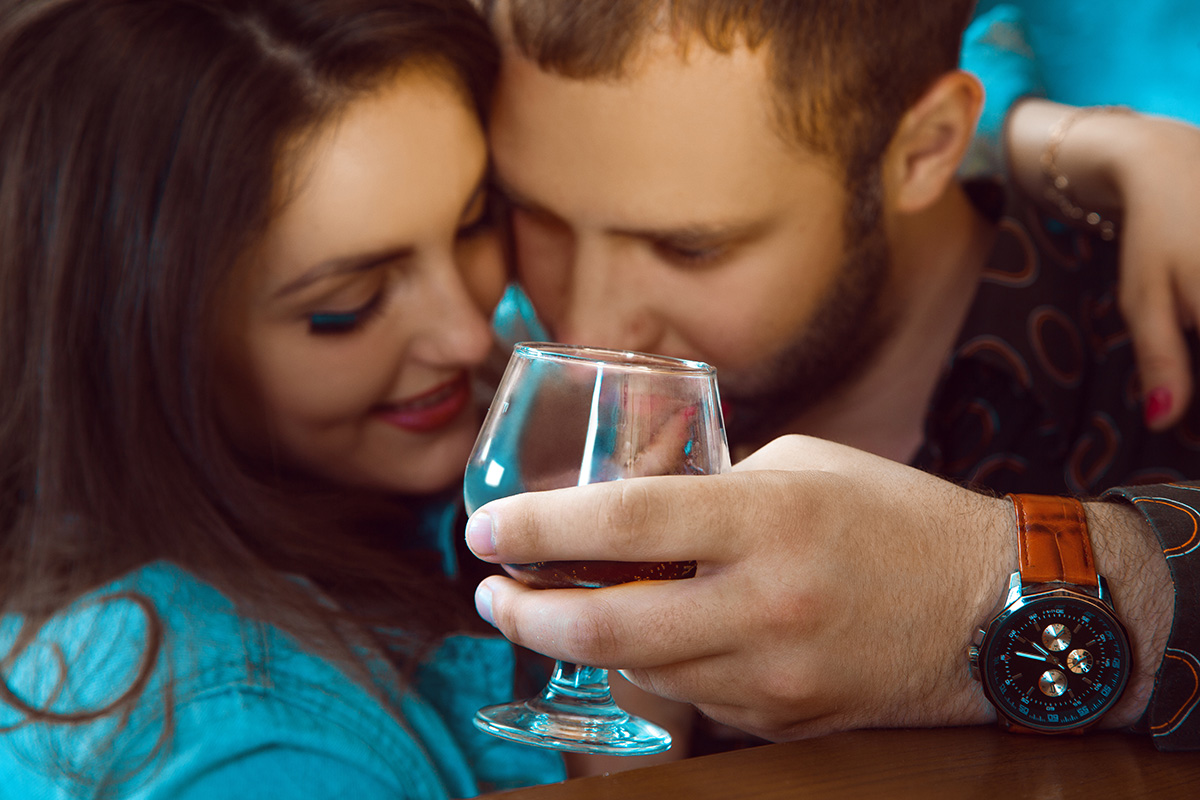 man with drink leaning on woman who's wondering Is My Loved One an Alcoholic