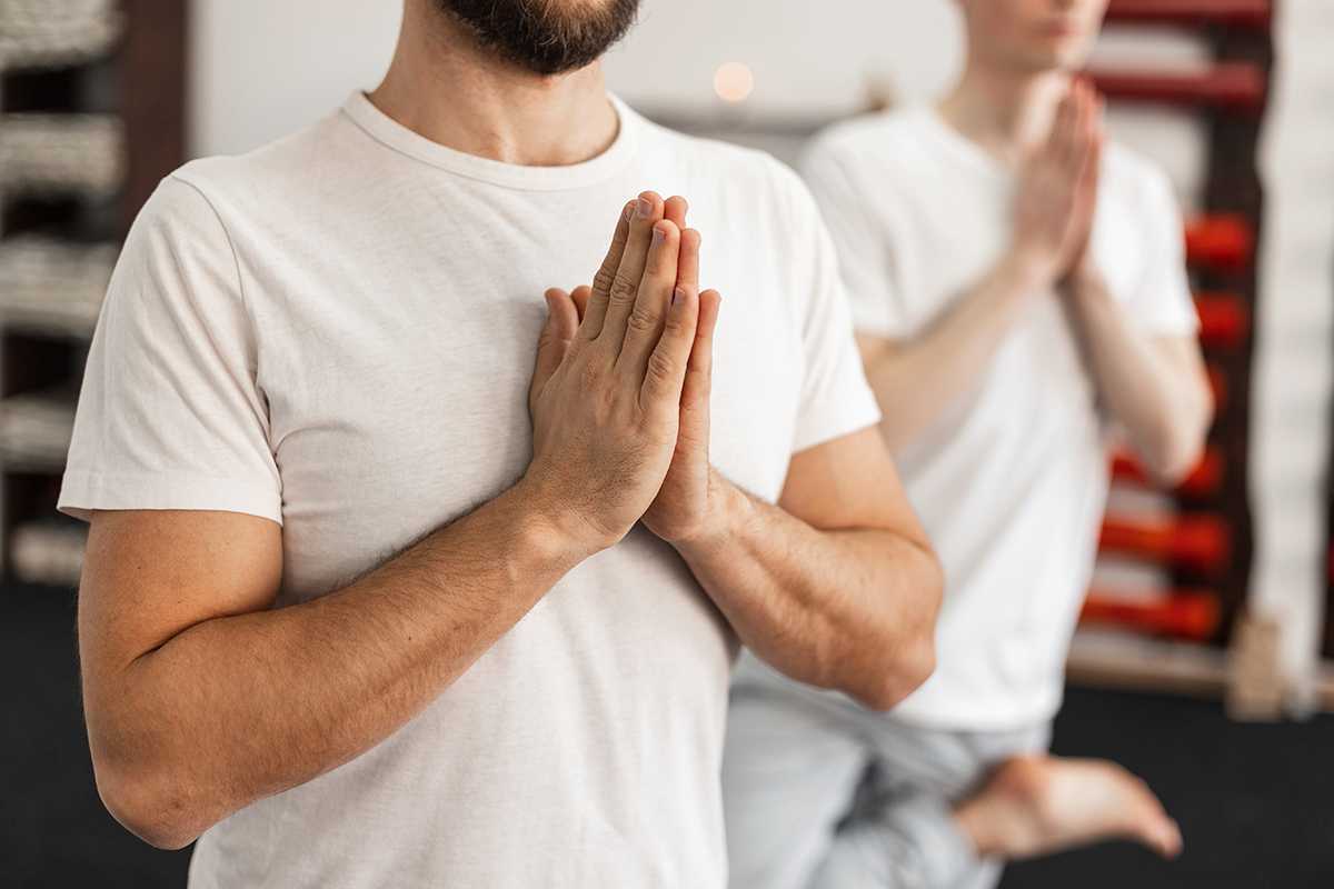 man practicing yoga to Prioritizing Your Recovery Goals