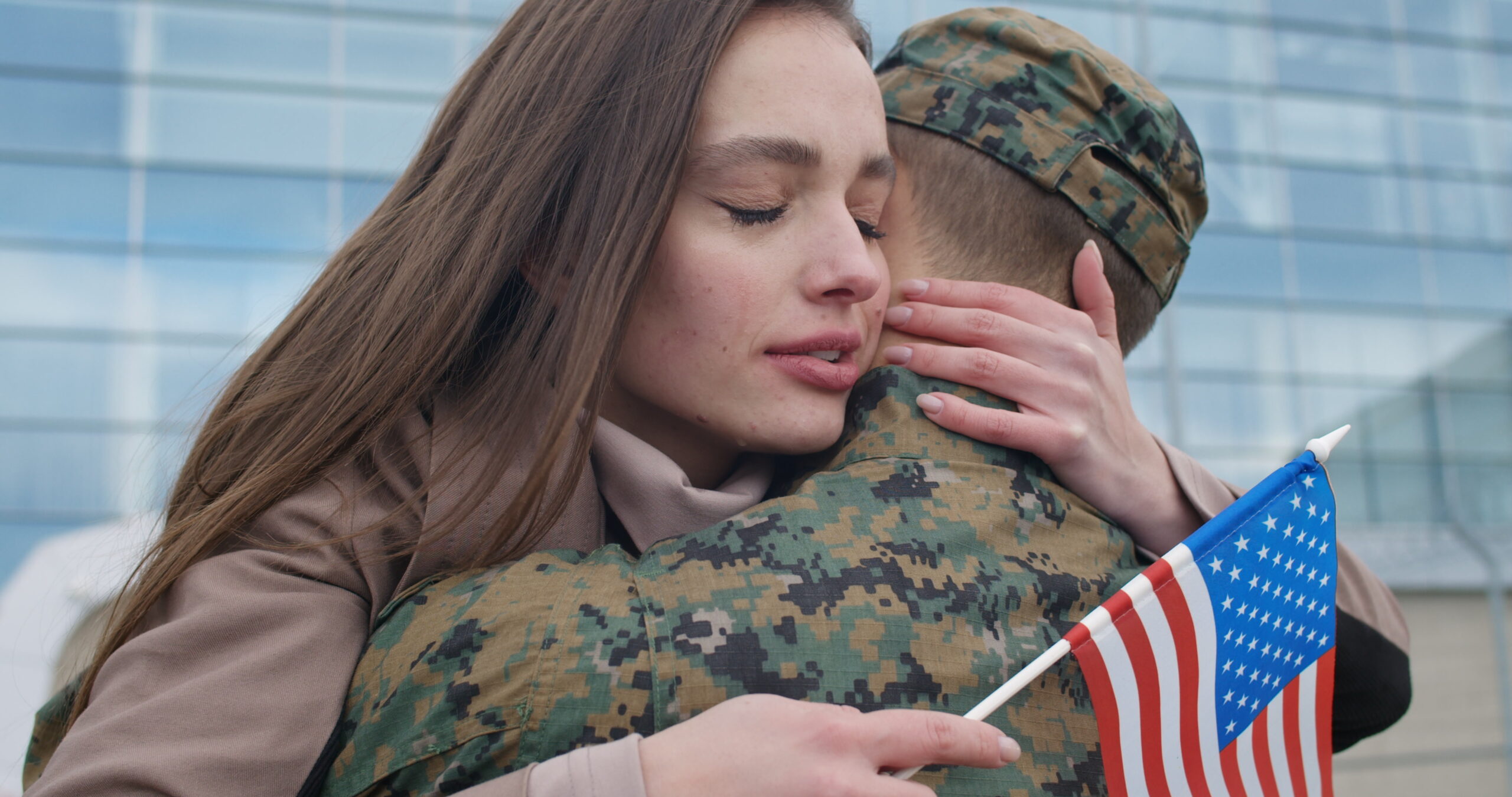 Close up of young woman happy face cuddling his military boyfriend while struggling with addiction.